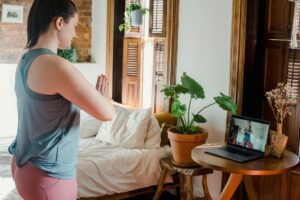 woman doing online yoga class